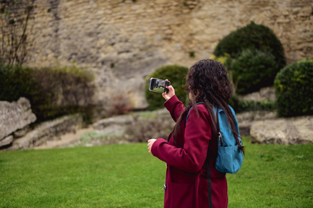 一名西班牙女子正在用手机拍摄美丽的景色。欧洲之旅图片下载