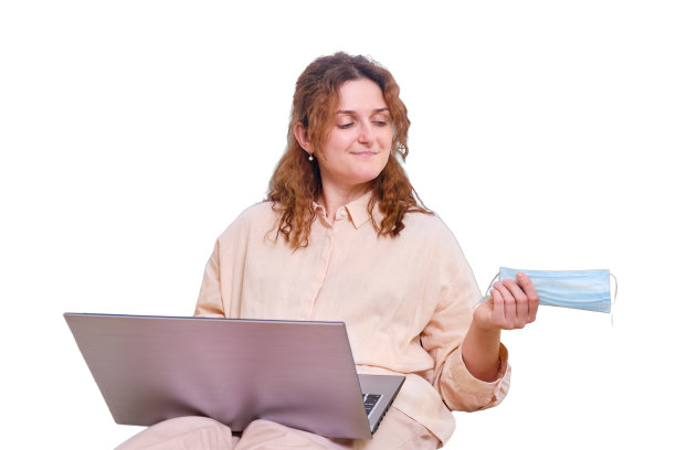 一名微笑的妇女摘下了她的医用口罩，孤零零地躺在白色的背景上。冠状病毒隔离结束后，女性乐于在家在线工作图片下载