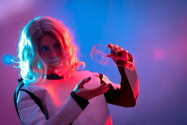 美丽的女人调整未来眼镜在黑暗的背景，未来和虚拟现实的概念图片下载