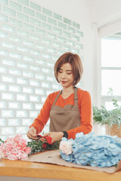 亚洲花店女制作美丽的花束图片下载
