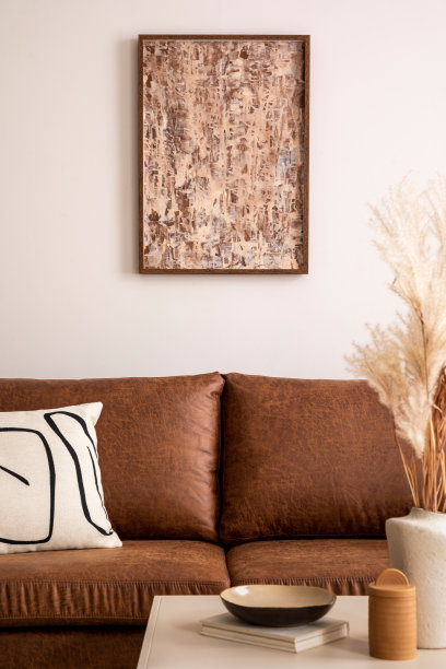 温暖舒适的室内客厅空间与模拟海报名声，棕色沙发，花瓶干花，装饰和个人配件。舒适的家居装饰。模板。图片下载