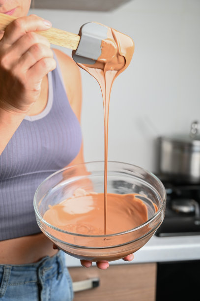 回火巧克力和制作巧克力的过程。糕点师正在用抹刀回火融化的巧克力图片下载