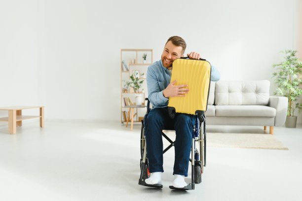一个残疾人提着箱子在家里准备度假。休闲的概念图片下载