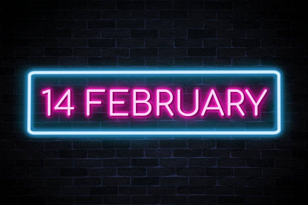 2月14日文本霓虹灯横幅砖墙背景。图片下载
