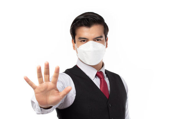 商人戴着口罩保护过滤pm2.5防污染、防雾霾、防病毒、Covid - 19并做停止手势。空气污染，环保理念。图片下载