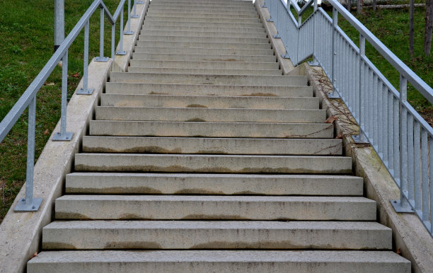 公共建筑的混凝土楼梯。安全楼梯有两个扶手，其中一个在学校入口处为12岁以下儿童降低了高度，无人机视角，顶部，点图片下载