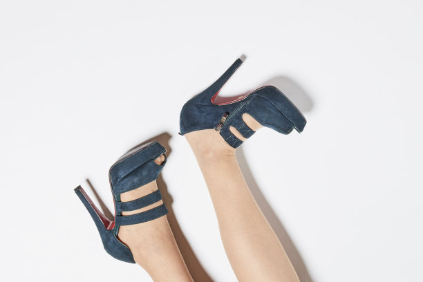 年轻女子在米色时尚时尚的皮革系带鞋。低部分的女人在黑色高跟鞋图片下载