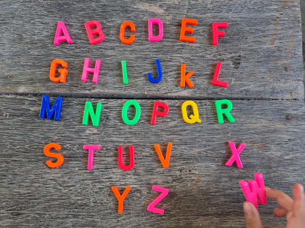 儿童手臂与塑料玩具学习字母的俯视图图片下载