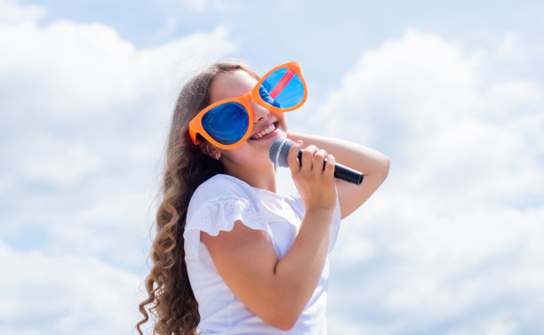 音乐是我的生命。孩子们用麦克风唱歌。开朗的活动经理。孩子们在聚会上玩得开心。快乐的歌手与麦克风。女孩唱歌。声乐学校的概念。卡拉ok俱乐部图片下载