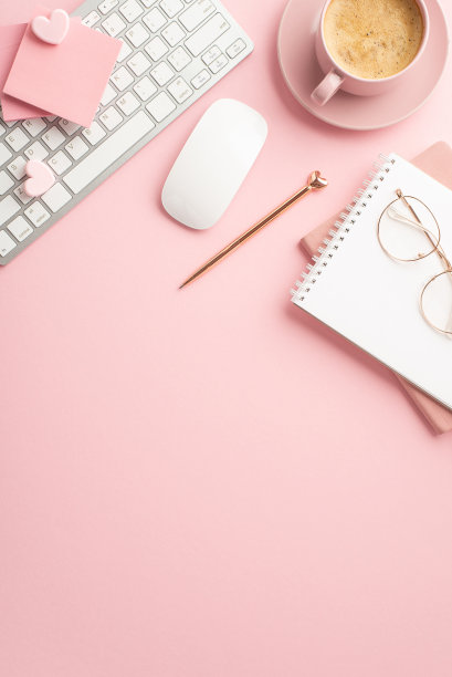 情人节的概念。俯视图垂直照片的键盘电脑鼠标时尚钢笔记事本和咖啡杯在茶托上孤立的粉彩粉红色背景与复制空间图片下载
