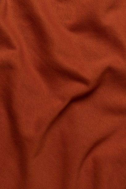 皱巴巴的橙色织物。图片下载