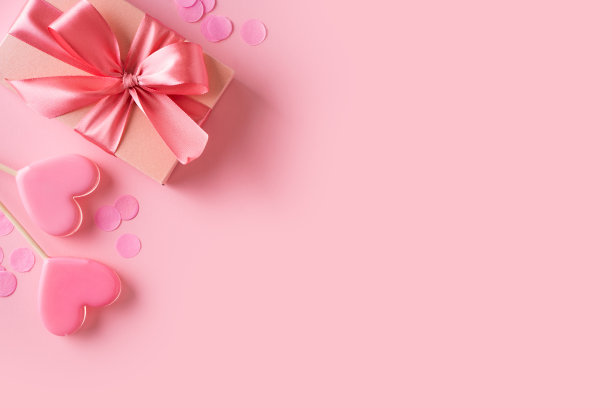 粉色的棒棒糖，红色的礼盒，粉色的背景图片下载