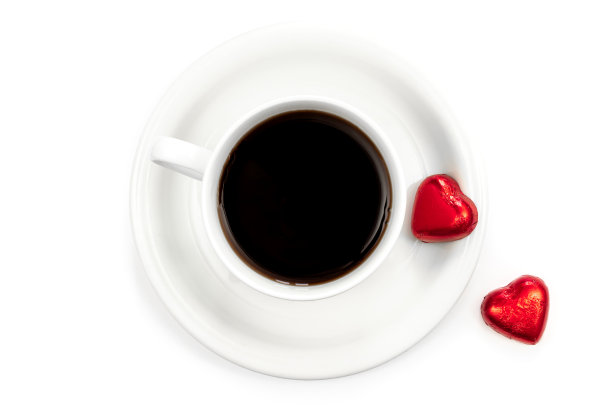 一杯咖啡和白色背景的心形巧克力，平铺。图片下载