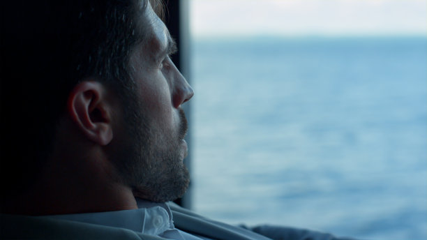 肖像商人看海景大窗口。企业家休假图片下载