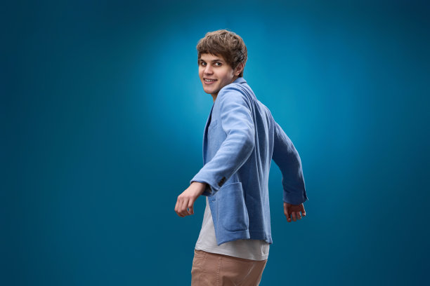 穿着黄色运动衫的男子在蓝色背景上跳舞图片下载