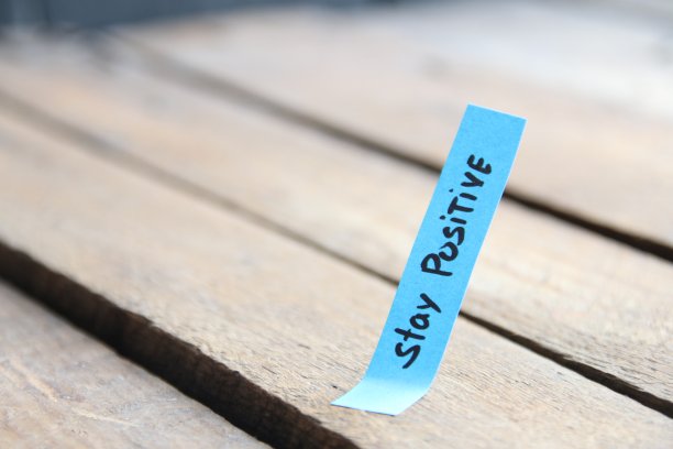 保持积极的态度。励志名言铭文在标签上。图片下载