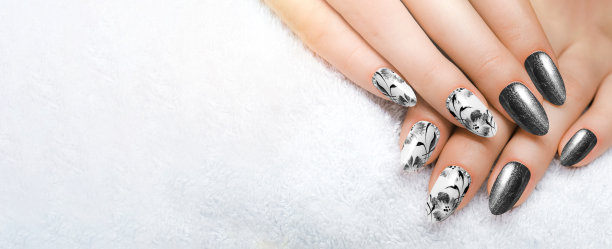 黑色的花指甲，又长又尖的指甲在白色的背景下闭合。图片下载