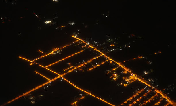 从飞机上看夜晚的城市和街道。图片下载
