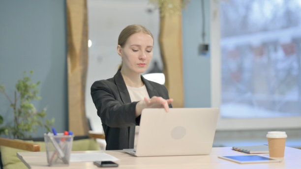 女商人关闭笔记本电脑后离开办公室图片下载