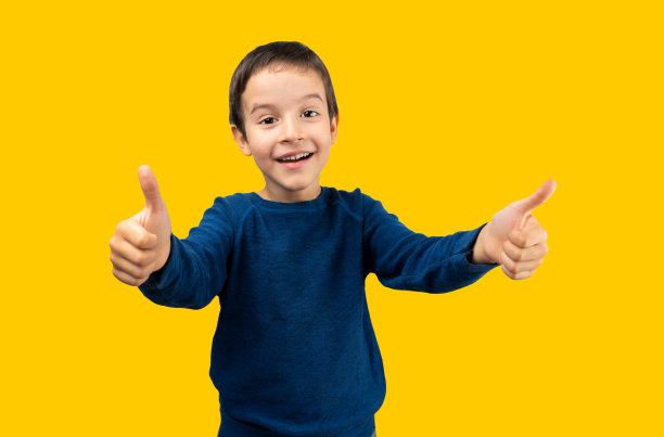 孩子穿着黄色背景的休闲毛衣图片下载