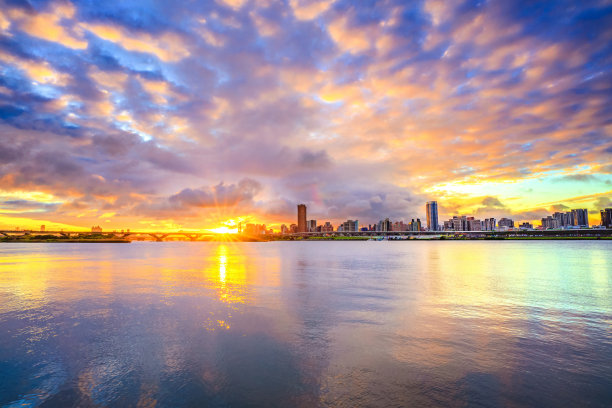 日落在河上，桥和城市。图片下载