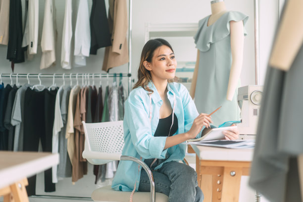 亚洲女设计师忙碌于服装设计工作室工作或学习图片下载