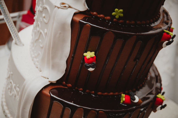 近距离拍摄的三层半深色设计的婚礼蛋糕图片下载