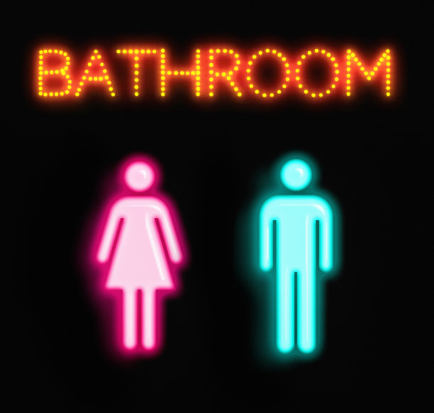 女性和男性浴室的标志被霓虹灯点亮，浴室这个词在他们上方的移动风格的灯中图片下载
