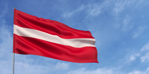 旗杆上的拉脱维亚国旗，蓝天背景。拉脱维亚国旗迎风飘扬，天空乌云密布。发短信的地方。3 d演示。图片下载