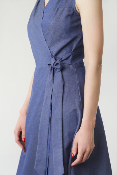 系列工作室的照片，年轻的女模特在棉牛仔无袖连衣裙包裹。图片下载