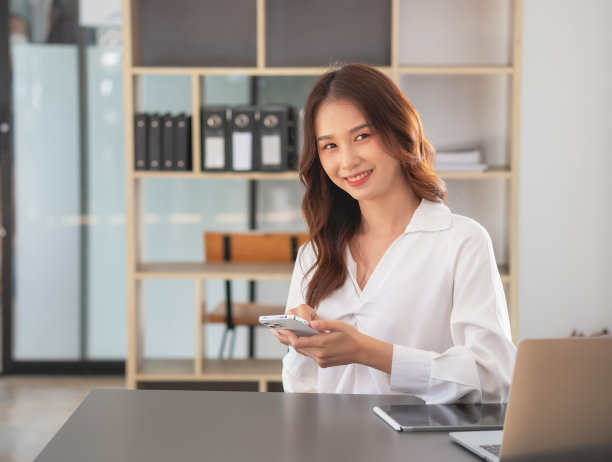 营销，财务，会计，计划，女商人用手机联系客户，告诉她公司是商业伙伴。图片下载