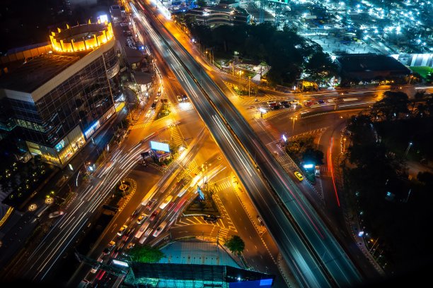 繁忙的高速公路路口在大都市中心的晚上。交通和基础设施概念。图片下载