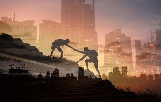 两个人的剪影爬山和帮助。图片下载