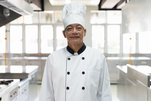 微笑的亚洲厨师男子在餐厅厨房的肖像。烹饪和食物概念图片下载