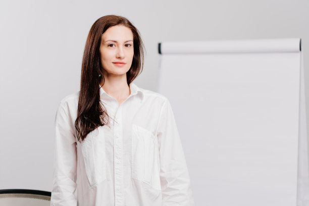 办公室里有个深色头发的女人拿着会议板。图片下载