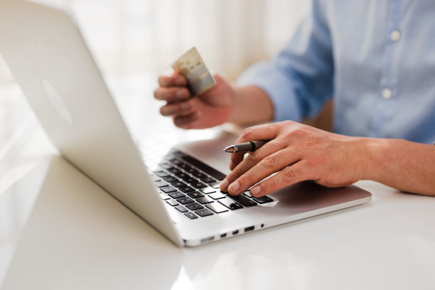 一名男子用信用卡和笔记本电脑网购图片下载