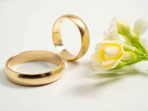 浅色背景上的结婚戒指。黄金戒指。图片下载