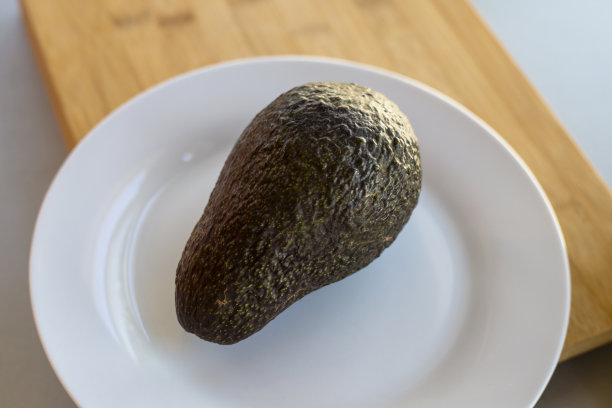 一个鳄梨的特写照片在盘子上的砧板图片下载