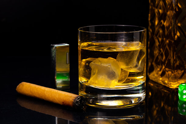 一瓶威士忌加冰，绿色骰子，古巴雪茄打火机图片下载