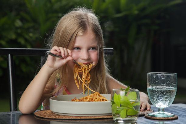 小女孩在餐厅吃意大利肉酱面图片下载