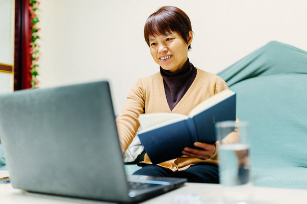 中年妇女在家用电脑查书——读书与生活，科技与生活图片下载