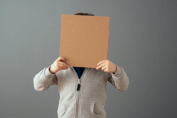 小男孩拿着一个干净的纸板牌子图片下载