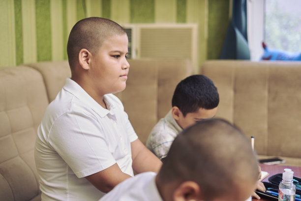 男性学生在家里上在线课时在课本上写字的画面图片下载