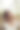 身着白色夏装的美丽女子正坐在乡间的草丛中。夕阳下浪漫女孩的肖像，温暖的太阳，自然美丽的女人图片下载