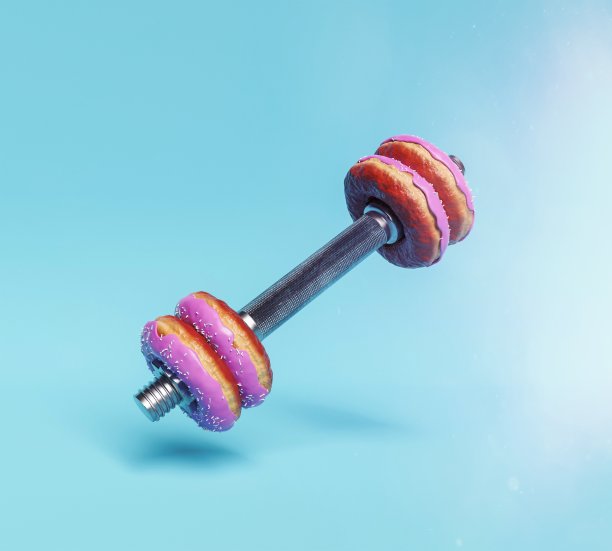 粉色甜甜圈哑铃。运动与节食概念图片下载