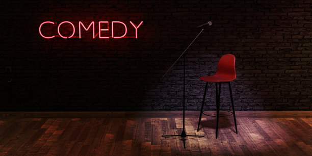 舞台上有麦克风，凳子上有红色霓虹灯，上面写着COMEDY。文本空间图片下载