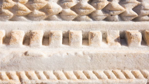 古老的背景。古希腊风格，卷曲的建筑元素，重复的图案。石灰岩。图片下载