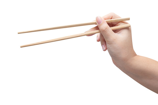 孤立的一个女人的手拿着一根木筷子。图片下载