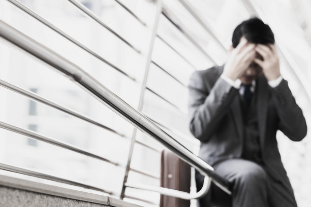 绝望疲惫头痛沮丧的亚洲商人办公室外的商人，手放在脑后头痛的成熟商人背景模糊肖像选择性聚焦图片下载