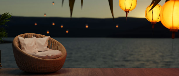 浪漫美丽的热带日落海滩景色的背景与柳条椅在木露台图片下载